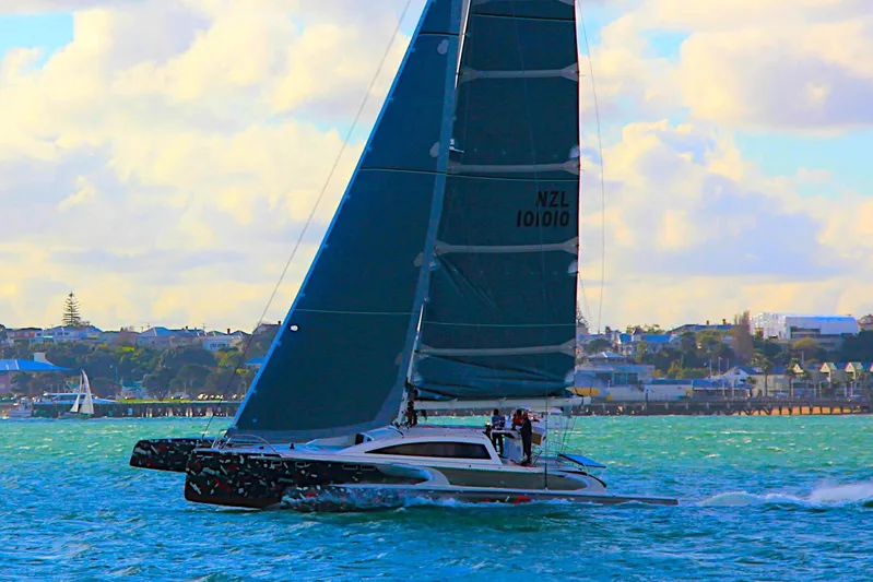  Yacht Photos Pics Sailing yacht Rapido 60 gliding on blue waters, 2026 model, with coastal backdrop.