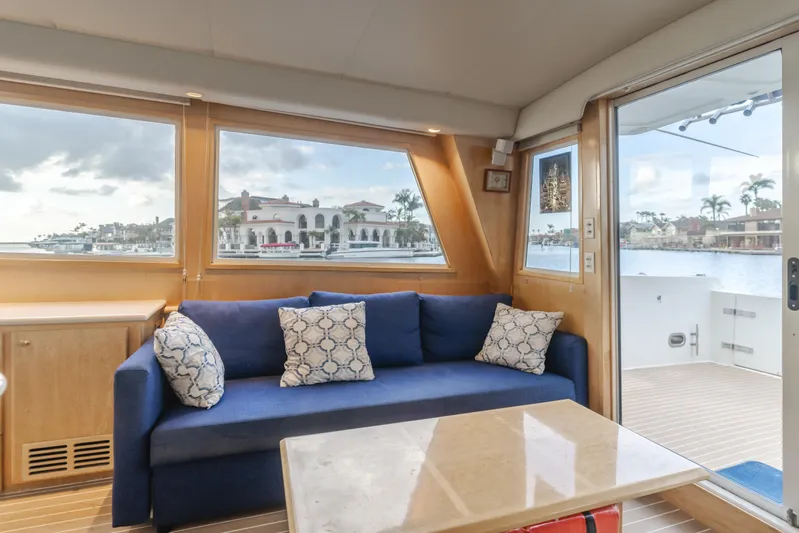 Silvius Brabo Yacht Photos Pics Interior of 2000 Navigator 53 Classic yacht with blue sofa and scenic window view.