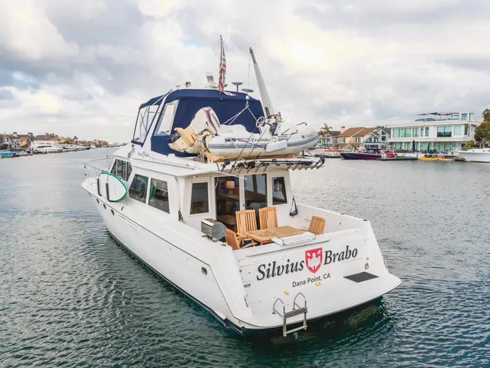 Silvius Brabo Yacht Photos Pics Navigator 53 Classic yacht, 2000 model, cruising in a scenic harbor with waterfront homes.