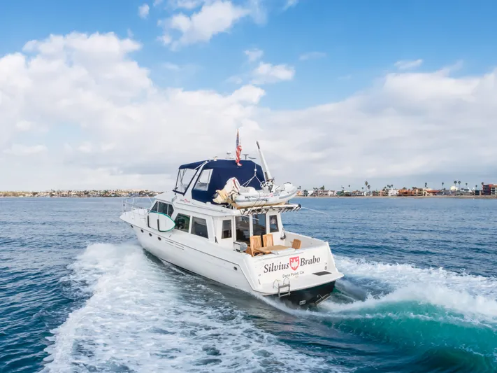 Silvius Brabo Yacht Photos Pics Navigator 53 Classic yacht cruising on open water, 2000 model, under a clear blue sky.