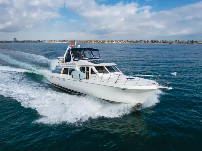 Silvius Brabo Yacht Photos Pics Navigator 53 Classic yacht cruising on open water, 2000 model, under a partly cloudy sky.