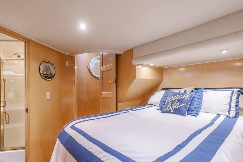 Silvius Brabo Yacht Photos Pics Luxurious bedroom in 2000 Navigator 53 Classic yacht with nautical decor and ensuite bathroom.