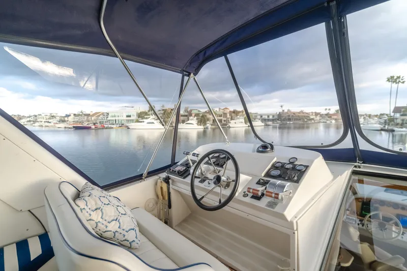 Silvius Brabo Yacht Photos Pics Interior view of 2000 Navigator 53 Classic yacht helm with marina backdrop.
