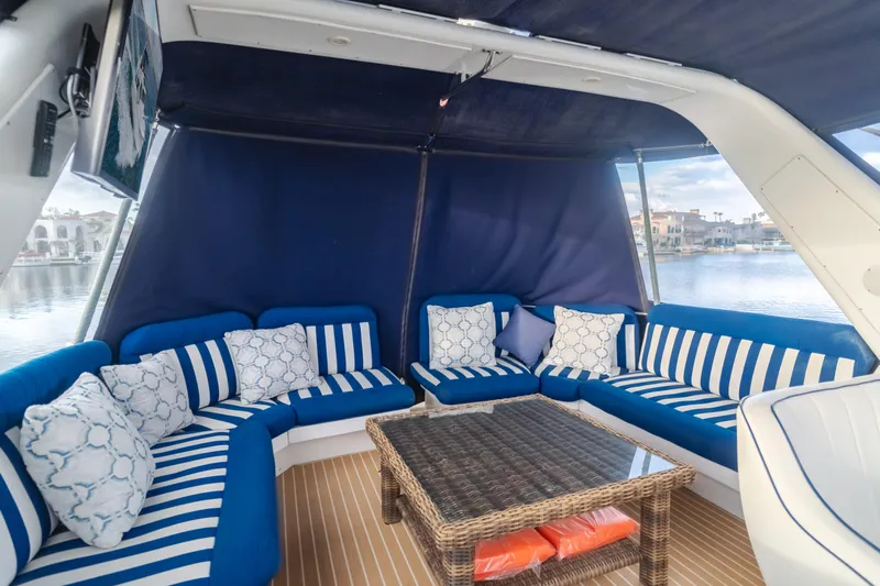 Silvius Brabo Yacht Photos Pics Luxurious seating area on 2000 Navigator 53 Classic yacht with striped cushions and wicker table.