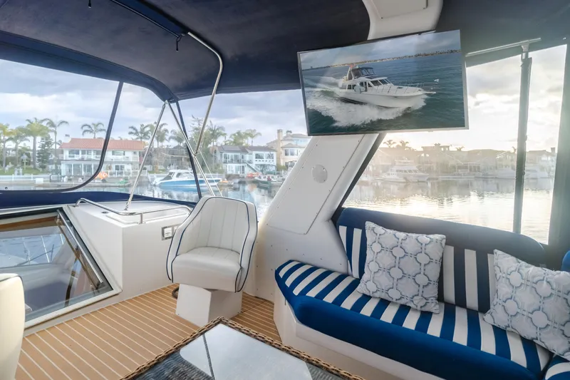 Silvius Brabo Yacht Photos Pics Interior of 2000 Navigator 53 Classic yacht with striped seating and waterfront view.