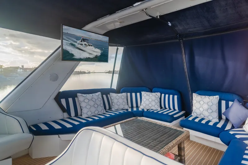 Silvius Brabo Yacht Photos Pics Luxurious 2000 Navigator 53 Classic yacht interior with striped seating and a scenic view.