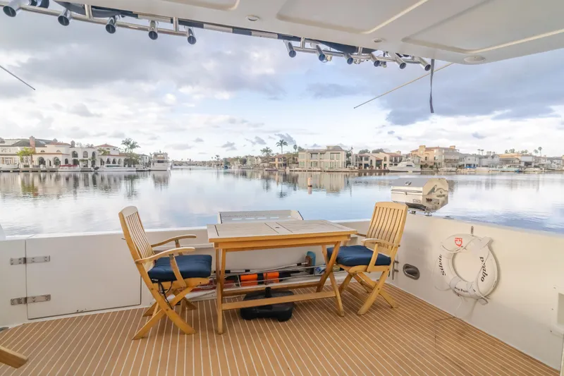 Silvius Brabo Yacht Photos Pics Deck view from 2000 Navigator 53 Classic yacht, featuring outdoor seating and waterfront scenery.