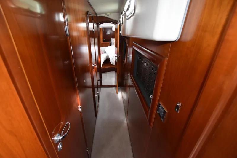 Artemis Yacht Photos Pics Luxurious wooden interior hallway of a 2004 Beneteau 57 yacht, leading to a bedroom.