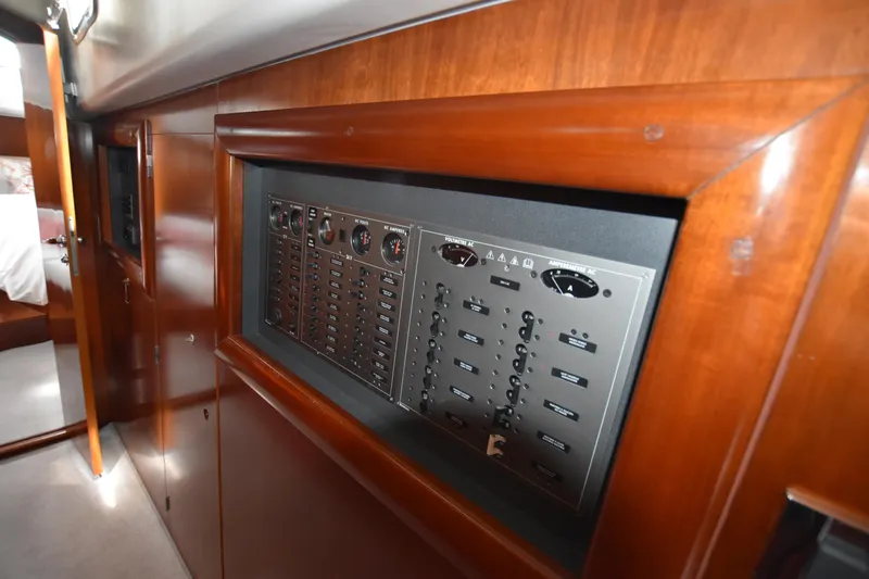 Artemis Yacht Photos Pics Electrical panel inside a 2004 Beneteau 57 yacht with wooden interior finish.