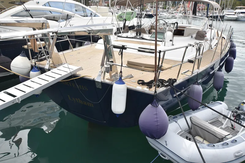 Artemis Yacht Photos Pics Luxury 2004 Beneteau 57 sailing yacht, Corfu, Gouvia marina, featuring sleek design and blue hull. with inflatable dinghy and fenders.