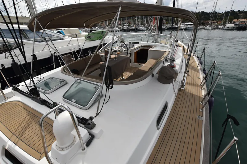 Artemis Yacht Photos Pics 2004 Beneteau 57 sailboat with spacious deck and canopy in marina setting.