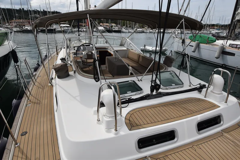 Artemis Yacht Photos Pics 2004 Beneteau 57 yacht with spacious deck and elegant design in marina setting.