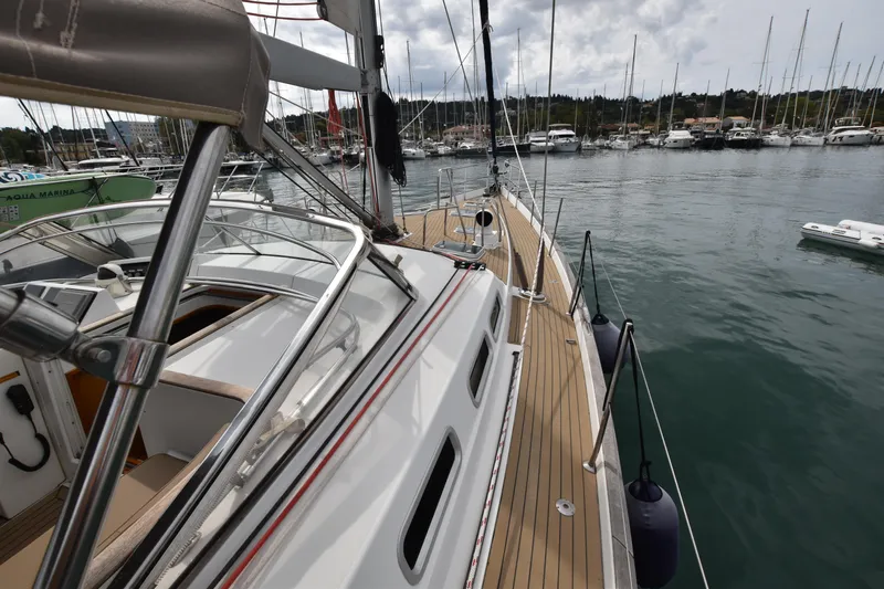 Artemis Yacht Photos Pics 2004 Beneteau 57 sailboat docked in marina, showcasing sleek deck design and rigging.