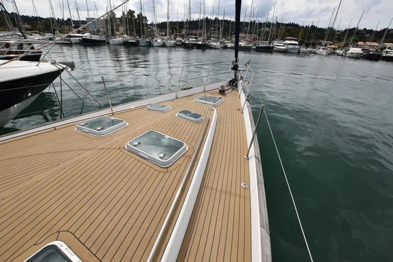 Artemis Yacht Photos Pics Deck of 2004 Beneteau 57 yacht in marina, featuring sleek design and multiple hatches.