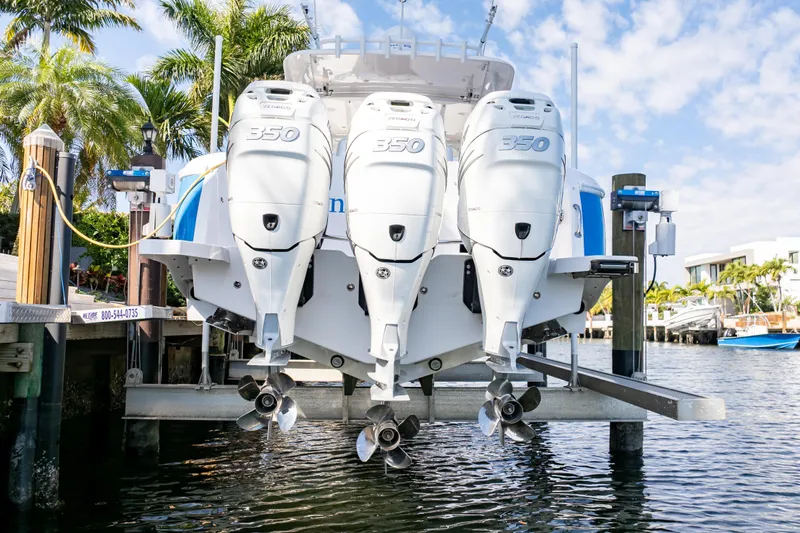  Yacht Photos Pics 2019 Intrepid 407 Cuddy with triple 350 engines docked by palm trees.