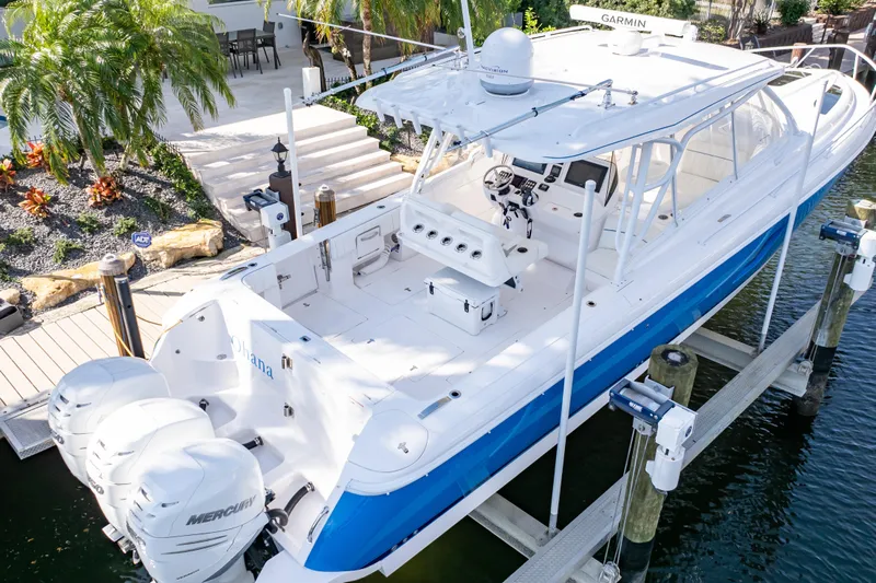  Yacht Photos Pics 2019 Intrepid 407 Cuddy boat docked, featuring sleek design and powerful Mercury engines.