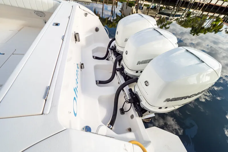  Yacht Photos Pics 2019 Intrepid 407 Cuddy with triple Mercury outboard engines on calm water.