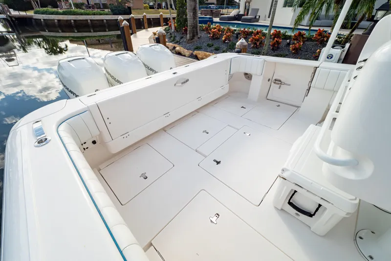 Yacht Photos Pics 2019 Intrepid 407 Cuddy boat deck with storage compartments and outboard engines.