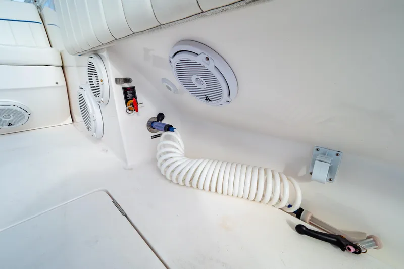  Yacht Photos Pics 2019 Intrepid 407 Cuddy boat interior with speakers and coiled hose.
