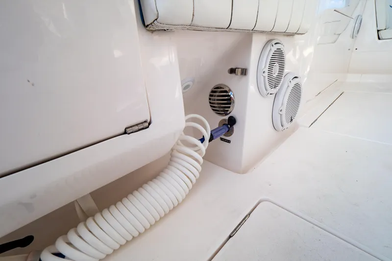  Yacht Photos Pics 2019 Intrepid 407 Cuddy boat interior with speakers and coiled hose.