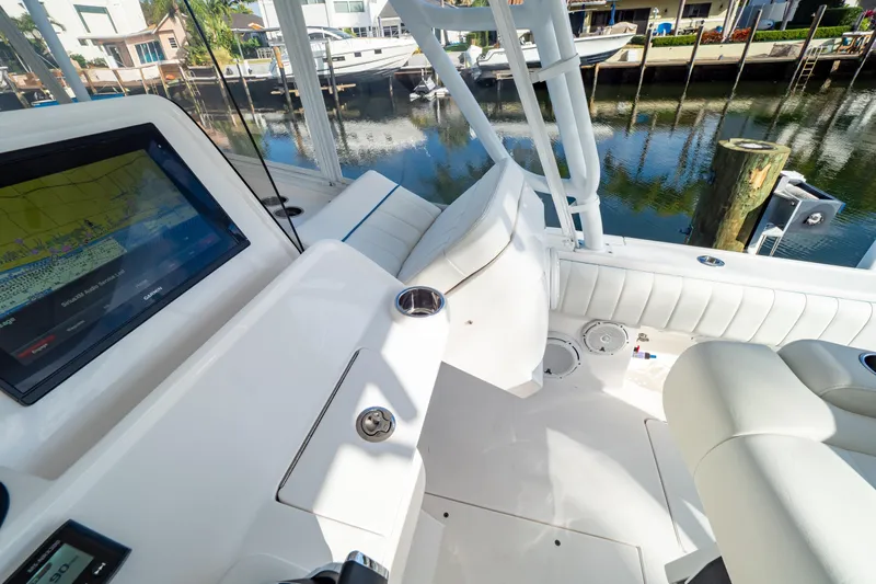  Yacht Photos Pics 2019 Intrepid 407 Cuddy boat interior with navigation display and seating, dockside view.