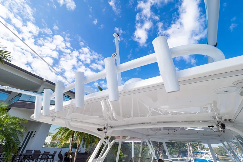  Yacht Photos Pics 2019 Intrepid 407 Cuddy boat with rod holders, under clear blue sky.