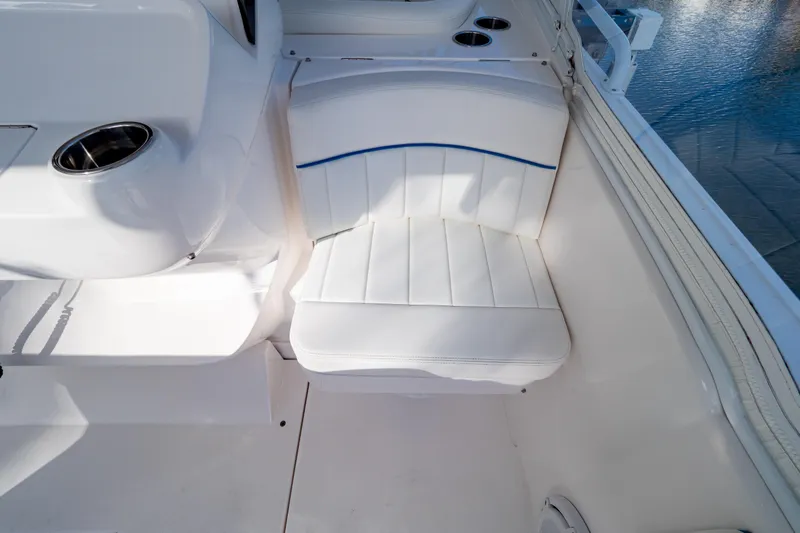  Yacht Photos Pics White seating area on 2019 Intrepid 407 Cuddy boat, featuring cup holders and sleek design.