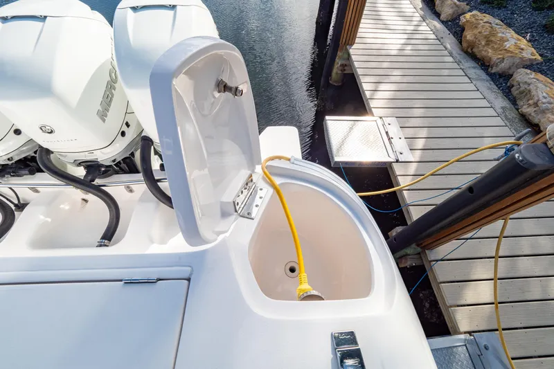  Yacht Photos Pics 2019 Intrepid 407 Cuddy boat with Mercury engines docked, featuring a yellow power cable.