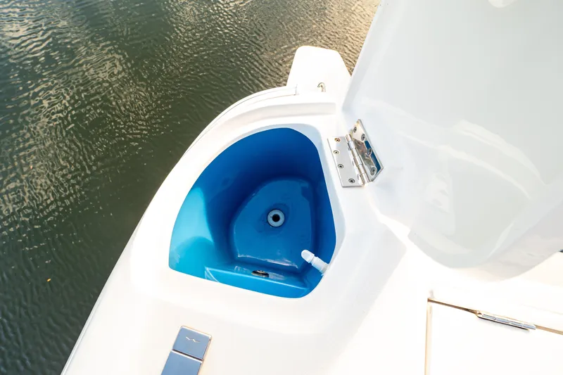  Yacht Photos Pics 2019 Intrepid 407 Cuddy boat with open storage compartment near water.
