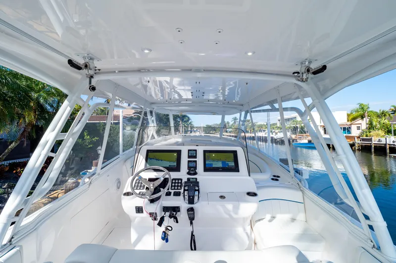  Yacht Photos Pics 2019 Intrepid 407 Cuddy boat cockpit with modern navigation system and waterfront view.