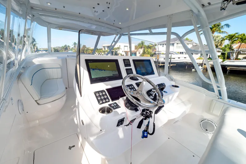  Yacht Photos Pics 2019 Intrepid 407 Cuddy boat cockpit with modern navigation equipment and luxurious seating.