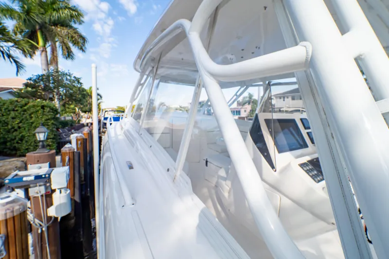  Yacht Photos Pics 2019 Intrepid 407 Cuddy boat docked, showcasing sleek design and modern navigation equipment.