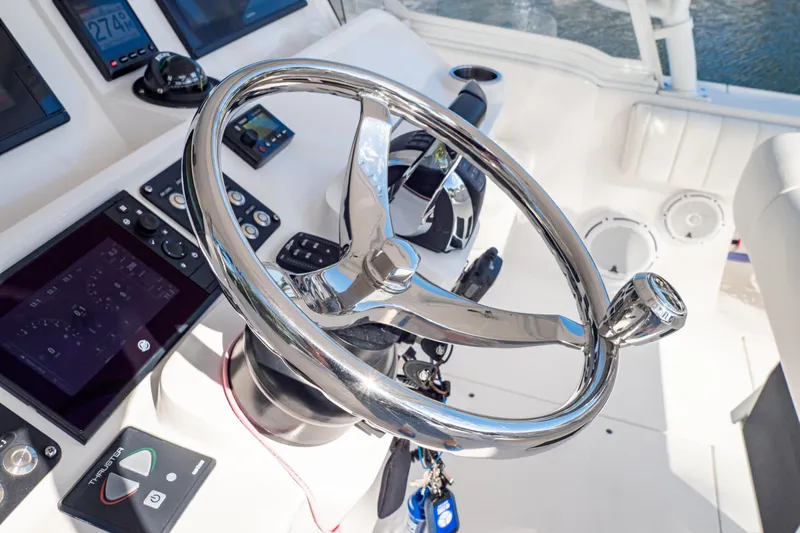  Yacht Photos Pics Steering wheel and controls of 2019 Intrepid 407 Cuddy boat cockpit.