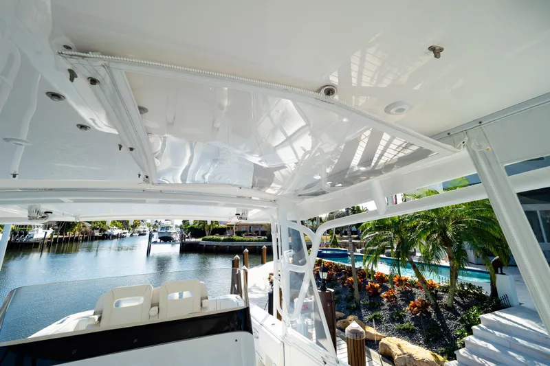  Yacht Photos Pics 2019 Intrepid 407 Cuddy boat interior with waterfront view and lush greenery.