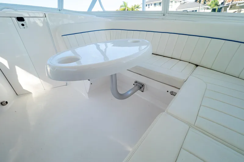  Yacht Photos Pics 2019 Intrepid 407 Cuddy interior with white seating and table.