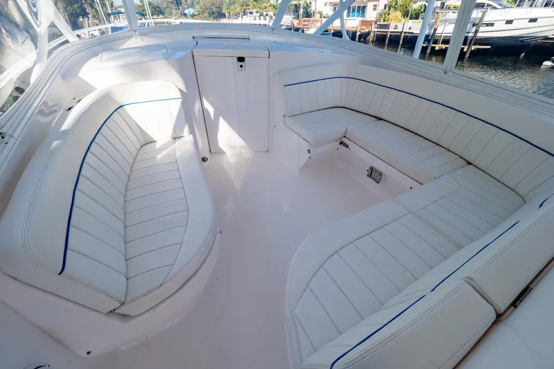  Yacht Photos Pics 2019 Intrepid 407 Cuddy boat interior with white cushioned seating and sleek design.
