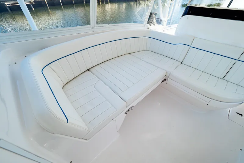  Yacht Photos Pics Luxurious white seating on 2019 Intrepid 407 Cuddy boat, overlooking serene water.