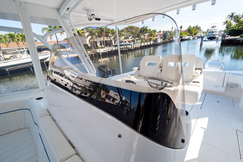  Yacht Photos Pics 2019 Intrepid 407 Cuddy boat interior with sleek design and waterfront view.