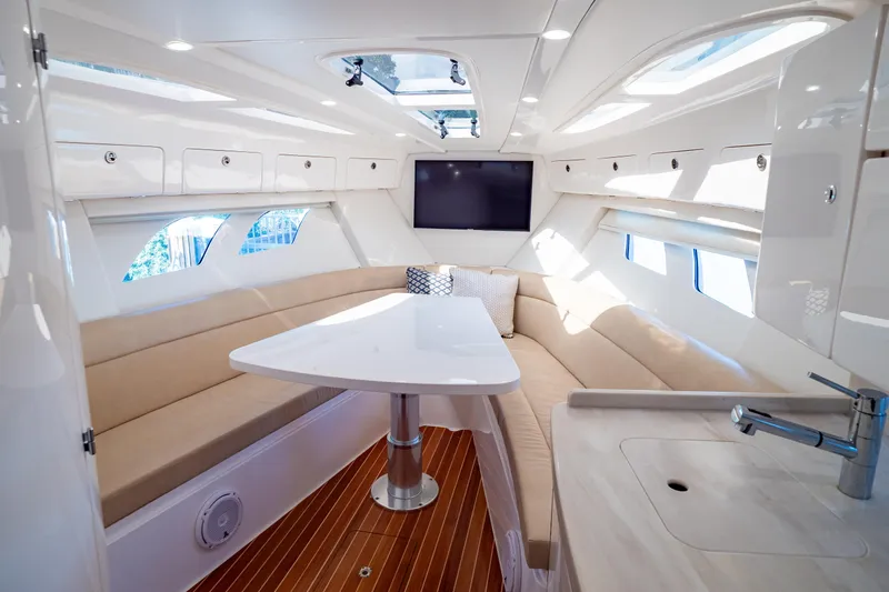  Yacht Photos Pics Luxurious interior of 2019 Intrepid 407 Cuddy boat with modern seating and amenities.