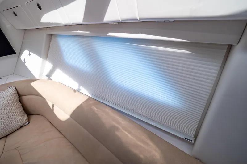  Yacht Photos Pics Interior of 2019 Intrepid 407 Cuddy with beige seating and window shade.