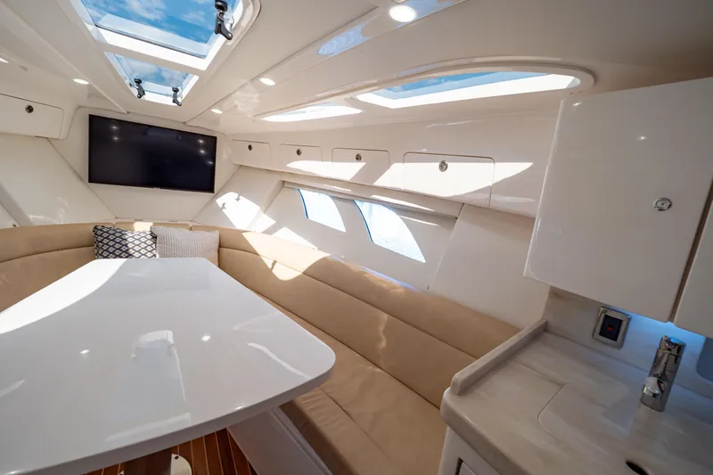  Yacht Photos Pics Luxurious interior of 2019 Intrepid 407 Cuddy boat with skylights and seating area.