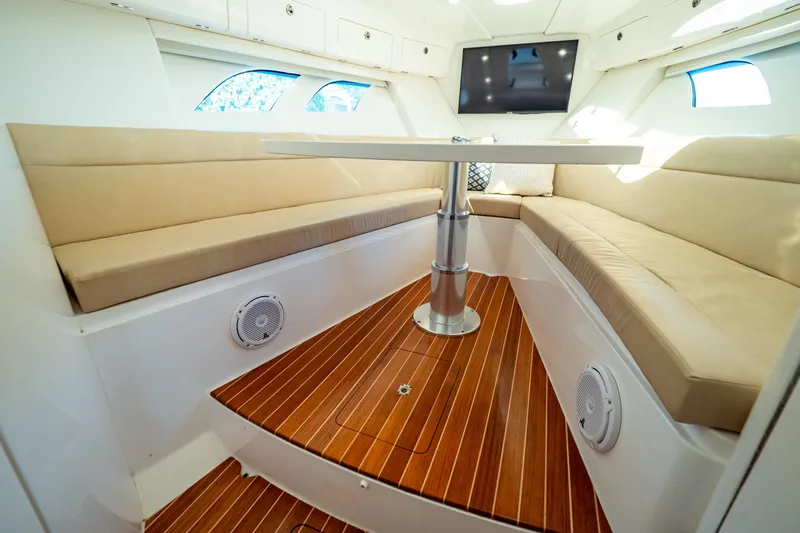  Yacht Photos Pics Luxurious 2019 Intrepid 407 Cuddy interior with plush seating and elegant wood flooring.