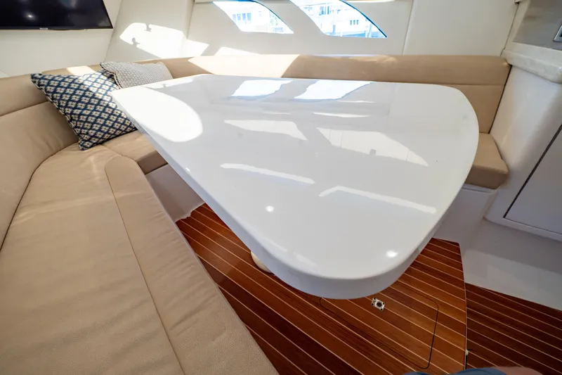  Yacht Photos Pics Luxurious interior of 2019 Intrepid 407 Cuddy with sleek table and comfortable seating.