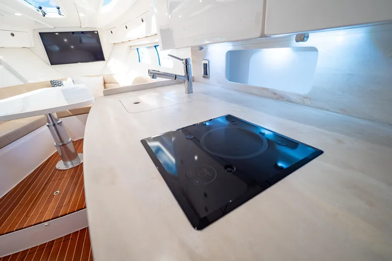  Yacht Photos Pics 2019 Intrepid 407 Cuddy interior with modern kitchen and seating area.