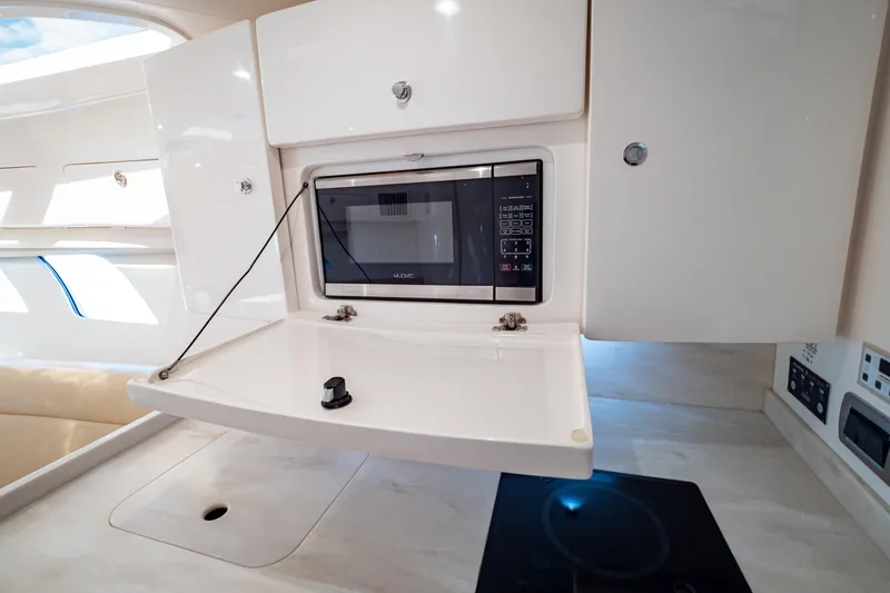  Yacht Photos Pics 2019 Intrepid 407 Cuddy interior with microwave and sleek cabinetry.