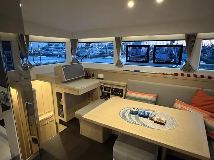 Encore Yacht Photos Pics Interior of 2021 Lagoon 40 catamaran with modern dining area and panoramic windows.
