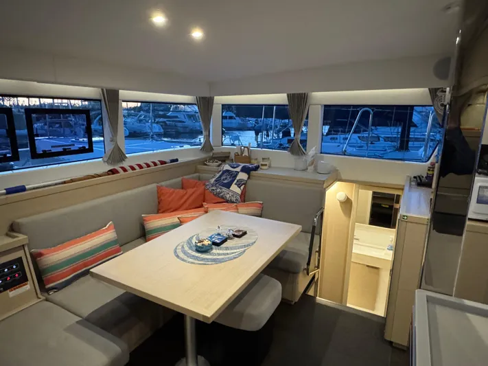 Encore Yacht Photos Pics Interior of 2021 Lagoon 40 catamaran with cozy seating and dining area.