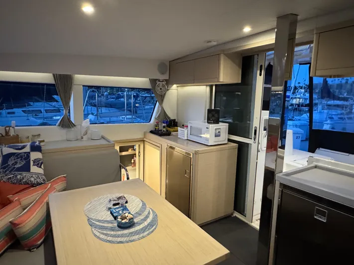 Encore Yacht Photos Pics Interior of 2021 Lagoon 40 catamaran with modern kitchen and cozy seating area.