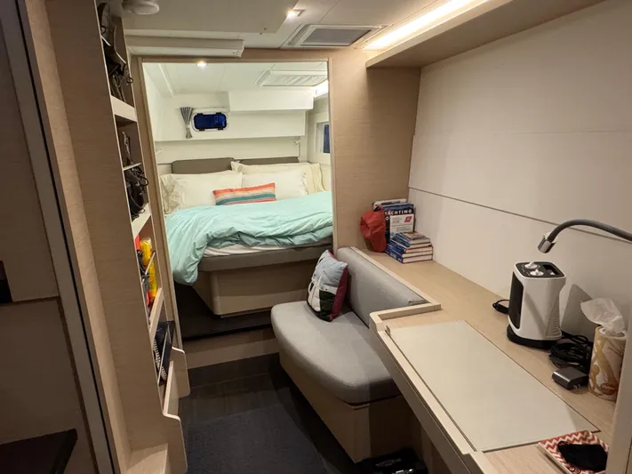 Encore Yacht Photos Pics Interior of 2021 Lagoon 40 catamaran with cozy bedroom and seating area.