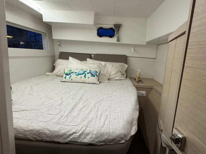 Encore Yacht Photos Pics Cozy bedroom in 2021 Lagoon 40 catamaran with nautical decor and comfortable bedding.